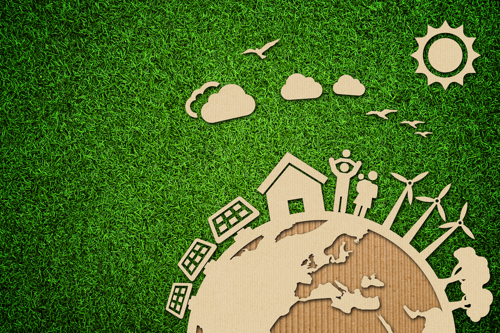 Umweltbewusste Energiekonzept-Illustration mit Pappe auf Gras.